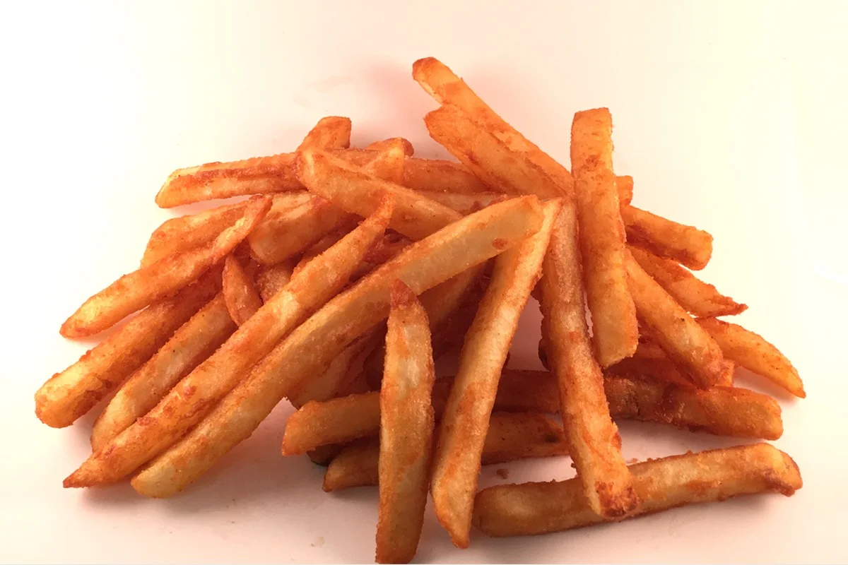 Golden crispy french fries on white background.